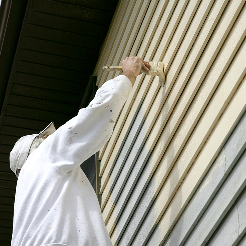 Man Painting Exterior of Home